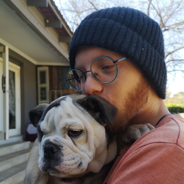 Kheagen Haskins holding a bulldog puppy